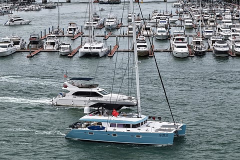 In this Aug. 23, 2025, aerial photo released by Xinhua News Agency, yachts return to dock ahead of Typhoon Kajiki in Sanya, southern China's Hainan Province.