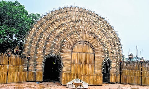 The puja pandal by Sahid Club made on a tribal theme using bamboo and palm leaves, at Saheed Nagar in Bhubaneswar