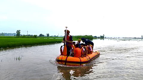 They navigated through deep floodwaters to reach the school building and transported students to safety.