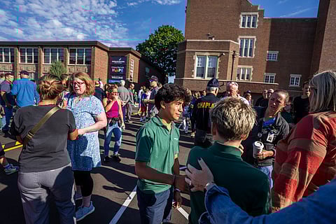 Students and parents await news during a mass shooting at the Annunciation Catholic School in Minneapolis on Wednesday, Aug. 27, 2025.