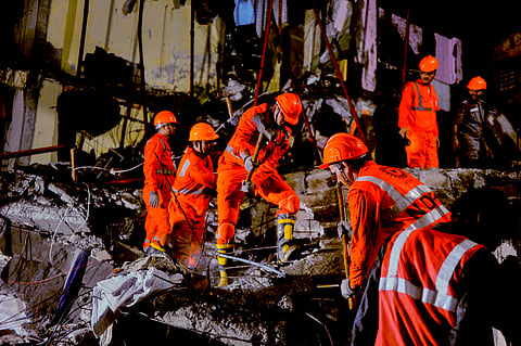 NDRF personnel during a rescue operation after the rear portion of a four-storey building crashed onto a chawl at Virar of Vasai taluka, in Palghar district, Maharashtra, Wednesday, Aug. 27, 2025. A 24-year-old woman and her toddler were killed and nine others injured after the 13-year-old "illegal" building collapsed, an official said on Wednesday.