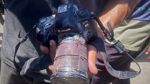 In this family handout photo, a person shows the blood-stained camera that freelance journalist Mariam Dagga, 33, was carrying when she was killed in a double Israeli strike on Nasser Hospital in Khan Younis, southern Gaza Strip, Monday, Aug. 25, 2025.