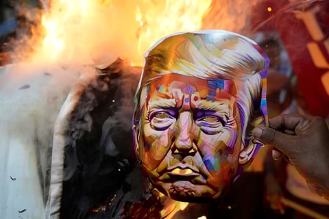 Activists of different trade unions and farmer's organizations burn an effigy of the U.S. President Donald Trump, near the American Consulate during a protest rally on trade tariffs and the war in Gaza in Kolkata, India, Wednesday, Aug. 13, 2025.