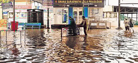 Security personnel stand guard at the inundated Basara temple on Friday.