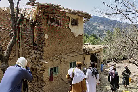Residents inspect the site of a building destroyed in what Taliban authorities said was a Pakistani deadly drone attack, in Spera district of Khost province, Afghanistan, Thursday, Aug. 28, 2025.