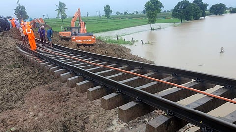 Railway staff carry out restoration works on Thursday after the track was damaged between Bhiknoor and Tallamada in Kamareddy following heavy rains.