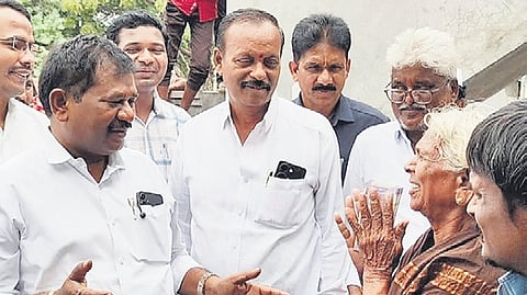 Minister Dola Sree Bala Veeranjaneya Swamy distributing pensions.