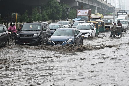 Vehicles stuck on a waterlogged road after heavy rainfall, at Ghazipur area , in New Delhi