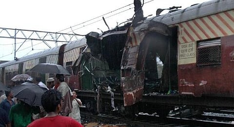In this July 11, 2006 file photo, a train coach is damaged by a bomb blast at Matunga railway station in Mumbai.