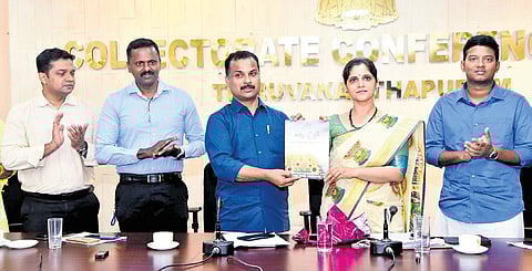 MLA V K Prasanth releasing the report ‘Poovili 2025’ at a function held at the collectorate conference hall. District Collector Anu Kumari receives the first copy.