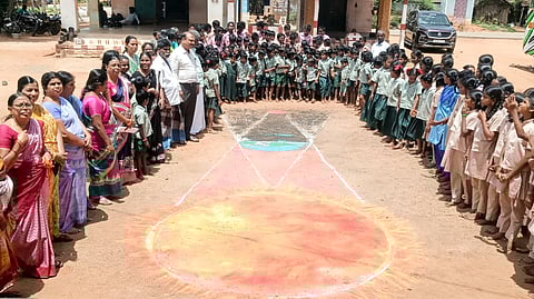 Students of the government high school at Posampatti, Tiruchy, along with others being shown how a lunar eclipse occurs, on Tuesday.