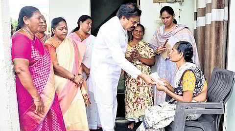 Minister Nandendla Manohar distributing pensions to beneficiaries.
