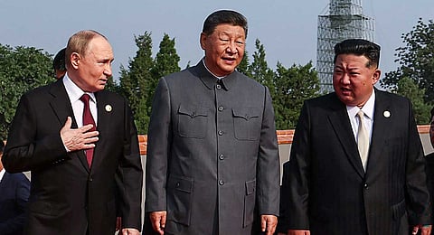 In this pool photograph distributed by the Russian state agency Sputnik, (L-R) Russia's President Vladimir Putin walks with China's President Xi Jinping and North Korea's leader Kim Jong Un before a military parade marking the 80th anniversary of victory over Japan and the end of World War II, in Beijing’s Tiananmen Square on September 3, 2025.