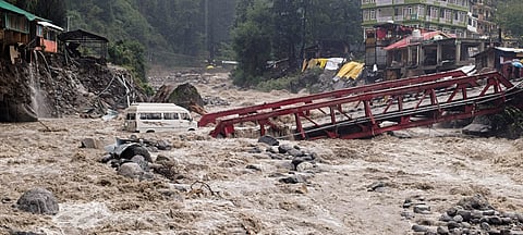 A vehicle stuck in Manalsu drain, flowing in spate, after heavy monsoon rain, at Manali in Kullu district, Himachal Pradesh, Tuesday, Sept. 2, 2025.