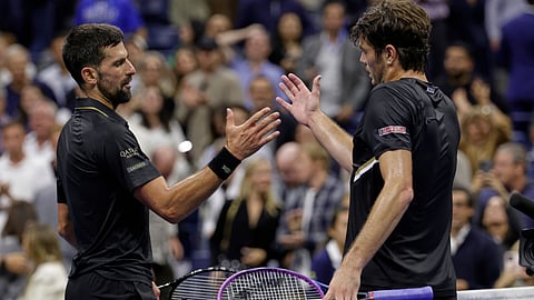 Novak Djokovic, of Serbia, shakes hands with Taylor Fritz, of the United States, after winning the match during the quarterfinal round of the U.S. Open tennis championships, Tuesday, Sept. 2, 2025, in New York.