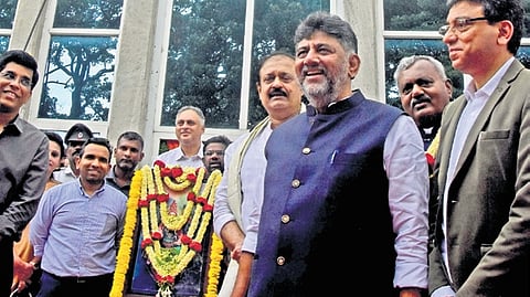 DCM DK Shivakumar unveils the GBA nameboard at the previous BBMP head office on Wednesday.