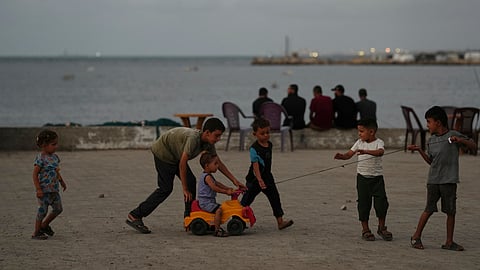 Palestinian children play at the seafront next to a tent camp in the Gaza City port, Tuesday, Sept. 2, 2025.