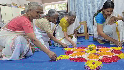 Inmates of Sree Poornathrayeesa Vridha Sadanam laying pookkalam on Thursday