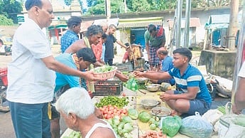 People buying vegetables at a market in Banki in Cuttack district.