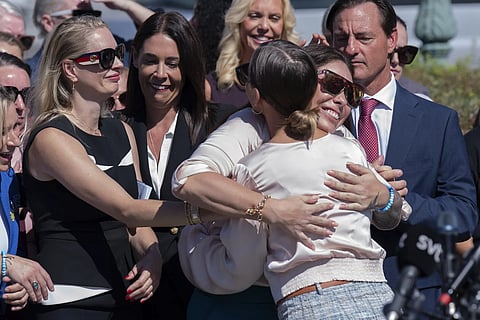 Anouska de Georgiou, left, Haley Robson, center, hug Marina Lacerda during a news conference at the U.S. Capitol, Wednesday, Sept. 3, 2025, in Washington.