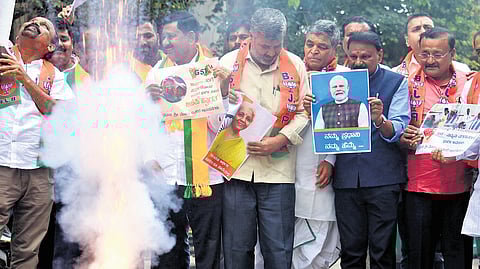 BJP workers and supporters celebrate the simplified GST regime by the Centre at the party office in Bengaluru on Friday.