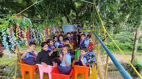 "Nests of birds, insects, and blooming flowers add to the charm of this swing classroom,” the headmaster said.