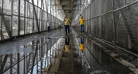 People at the Old Railway Bridge as the Yamuna river continues to flow in spate during the monsoon season, in New Delhi, Thursday, Sept. 4, 2025.