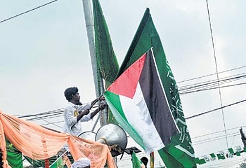 A youth waving Palestine flag