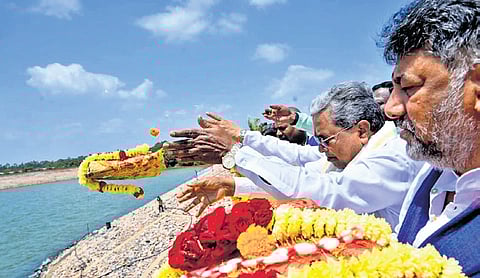 Chief Minister Siddaramaiah and Deputy CM DK Shivakumar offer bagina to the Krishna river at Almatti reservoir, in Vijayapura on Saturday.