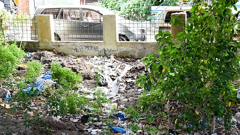 Waste dumped under the Odathurai road overbridge in Tiruchy on Friday.