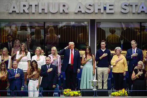 Joined by U.S. Attorney General, Pam Bondi,, Arabella Kushner, Jared Kushner, Susie Wiles, White House Chief of Staff, and Secretary of Treasury, Scott Bessent, President Donald Trump, center, salutes during the playing of the national anthem before the start of the men's singles final between Carlos Alcaraz, of Spain, and Jannik Sinner, of Italy, at the U.S. Open tennis championships, Sunday, Sept. 7, 2025