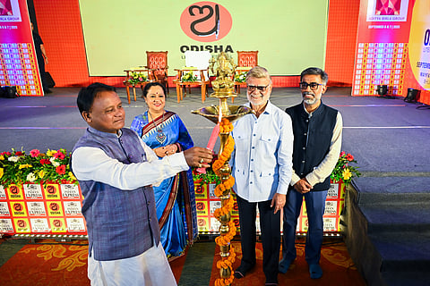 Chief Minister Mohan Charan Majhi lighting the lamp to inaugurate the Odisha Literary Festival-2025 as TNIE CEO Lakshmi Menon, editorial director Prabhu Chawla and resident editor Siba Mohanty look on, in Bhubaneswar on Saturday.
