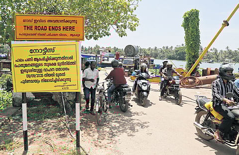 The notice board put up near the KELTRON ferry states that traffic will be completely restricted to facilitate the bridge construction.