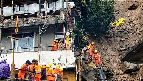 NDRF personnel during a search and rescue operation after two houses collapsed following a landslide due to heavy rainfall, at Akhada Bazaar area, in Kullu district, Himachal Pradesh, Saturday, Sept. 3, 2025.