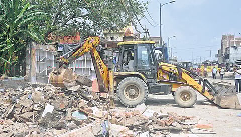 Illegal structures being demolished as part of an anti-encroachment drive at the Ghazipur dairy farm area.