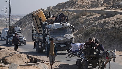 Displaced Palestinians fleeing northern Gaza carry their belongings along the coastal road toward southern Gaza on Tuesday, Sept. 9, 2025, after the Israeli army issued evacuation orders from Gaza City.