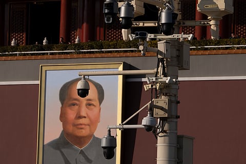 Security cameras are seen by a portrait of late Chinese leader Mao Zedong near Tiananmen Gate in Beijing, Tuesday, Feb. 18, 2025.