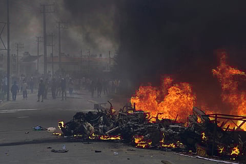 Protesters burn vehicles and tires during protests against social media ban and corruption in Kathmandu, Nepal, Tuesday, Sept. 9, 2025.