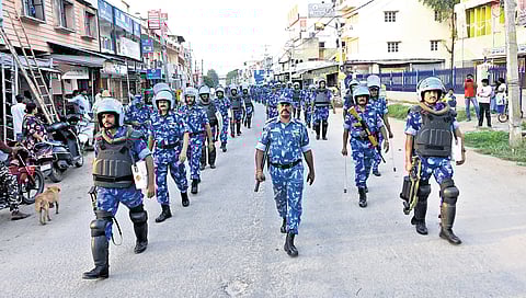 As part of security measures, police and RPF personnel take out a route march in Maddur on Tuesday.