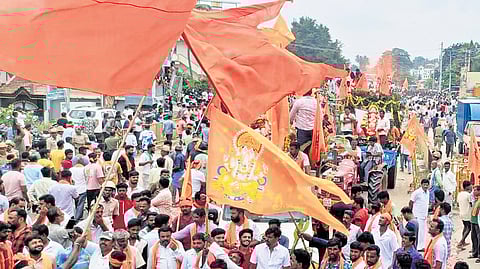 People participate in a mega procession to immerse Ganesha idols in Maddur, Mandya district, on Wednesday.