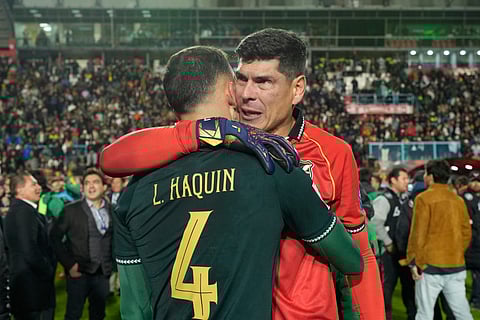 Bolivia's goalkeeper Carlos Lampe and teammate Luis Haquin celebrate their team's 1-0 victory over Brazil at the end of a World Cup 2026 qualifying soccer match at Villa Ingenio stadium in El Alto, Bolivia, Tuesday, Sept. 9, 2025.