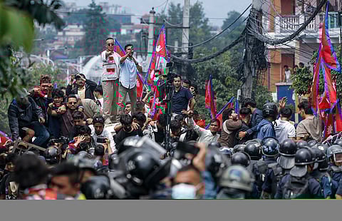 Students raise slogans during a protest over alleged corruption and Nepal government's decision to ban social media sites, in Kathmandu, Monday, Sept. 8, 2025.