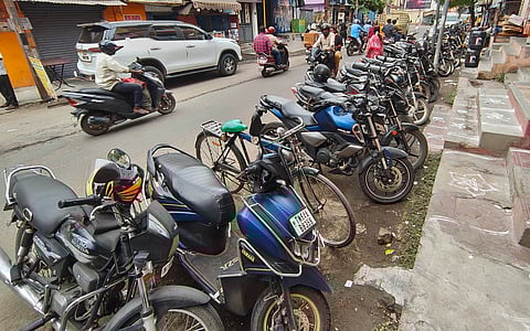 Vehicles parked in the road side affecting the traffic flow in city roads in Madurai on Tuesday.