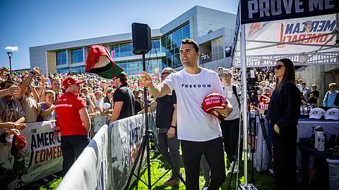 Charlie Kirk hands out hats before speaking at Utah Valley University in Orem, Utah, Wednesday, Sept. 10, 2025.