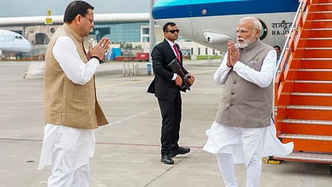 In this image received on Sept. 11, 2025, Uttarakhand Chief Minister Pushkar Singh Dhami welcomes Prime Minister Narendra Modi on his arrival to review the aerial survey of disaster-affected areas and ongoing relief, rescue and rehabilitation operations, in Dehradun, Uttarakhand.