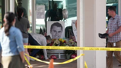 Well-wishers pay their respects at a makeshift memorial at the national headquarters of Turning Point USA after the shooting death of Charlie Kirk, CEO of the organization, during a Utah college event Wednesday, Sept. 10, 2025, in Phoenix.