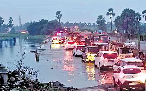 Floodwaters from the overflowing Katakshapur lake in Atmakur mandal, Warangal district, affected vehicular traffic on National Highway-163 on Friday evening.