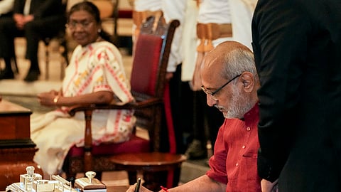 Vice-President of India CP Radhakrishnan signs a register after taking oath, at Rashtrapati Bhavan, in New Delhi, Friday, Sept. 12, 2025. President Droupadi Murmu looks on.