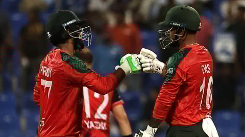 Bangladesh's captain Litton Das (R) and his teammate Towhid Hridoy bump their fists during the Asia Cup 2025 Twenty20 international cricket match between Bangladesh and Hong Kong on September 11, 2025.