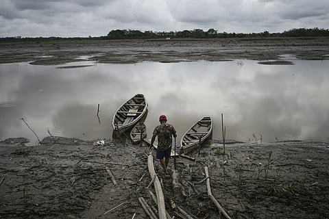 A fisherman walks to his boat in Santa Rosa, Peru, an island on the Amazon river on August 17, 2025
